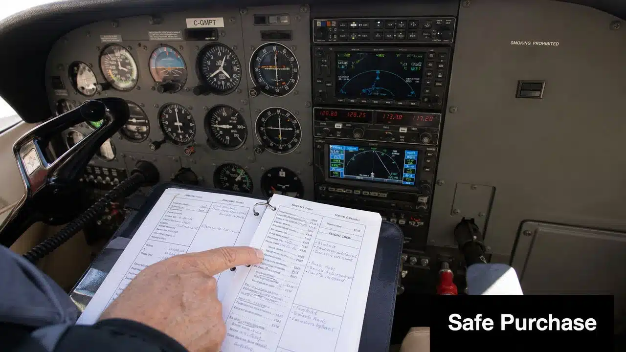 Your Guide to the Yellow Jacket Flying Club & Beyond 3 A pilot reviews a flight logbook inside the cockpit of a small aircraft before departure.