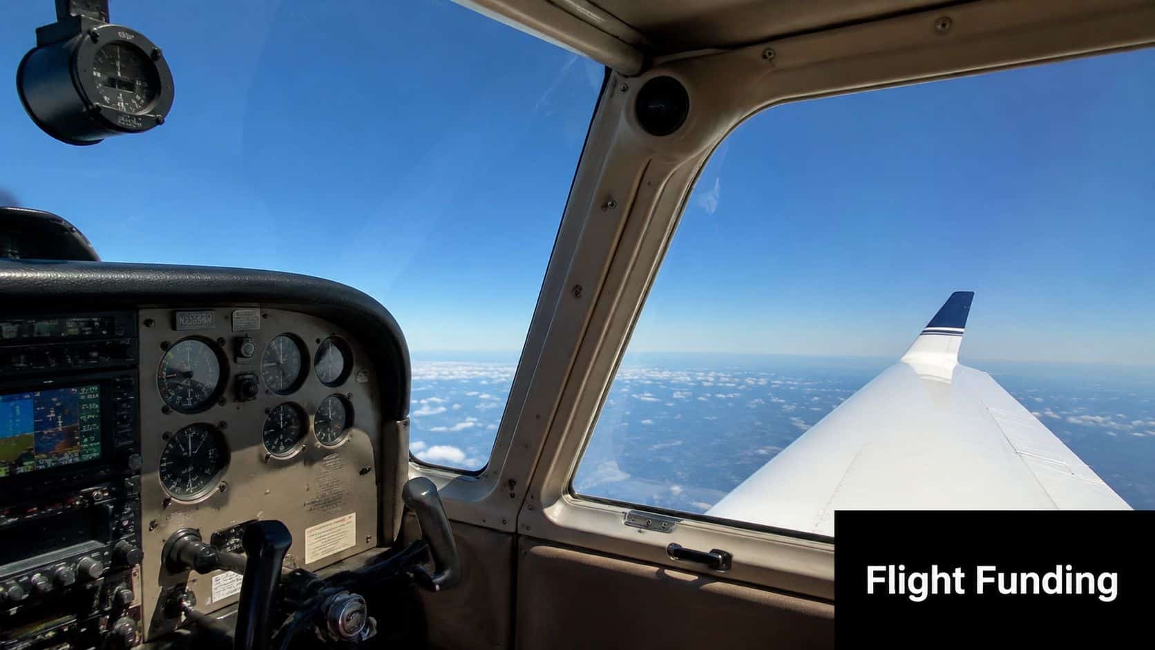 Your Private Pilot License Scholarship Guide for 2026 2 A view from inside the cockpit of a small aircraft looking out at the sky