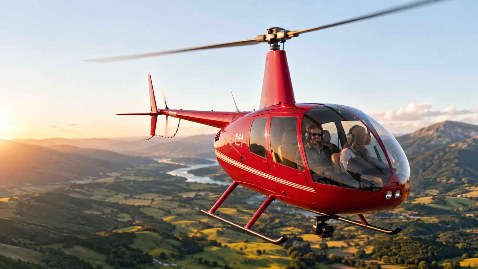 Scenic Helicopter Flights: What to Expect on a Tour 2 A red Robinson R44 helicopter flying over a scenic valley landscape during a golden sunset.