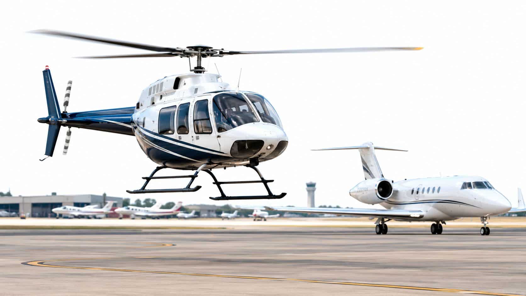 Air Traffic Patterns Explained for Pilots 4 A helicopter hovering near a private jet on an airport tarmac under a clear sky.