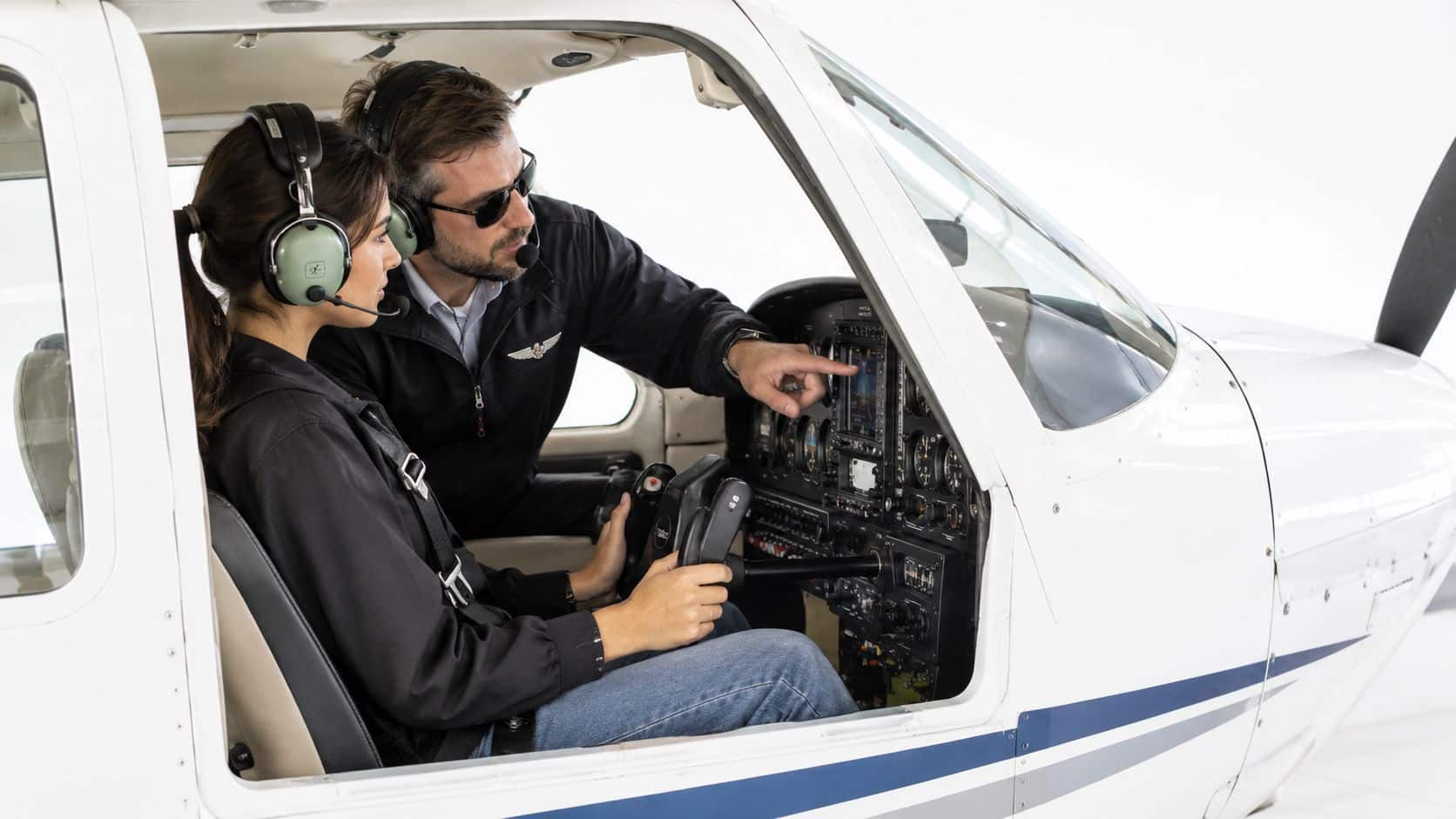 Pilot Certificate Maintenance: A Practical How-To Guide 4 A flight instructor pointing to the instrument panel while training a student pilot in a small aircraft