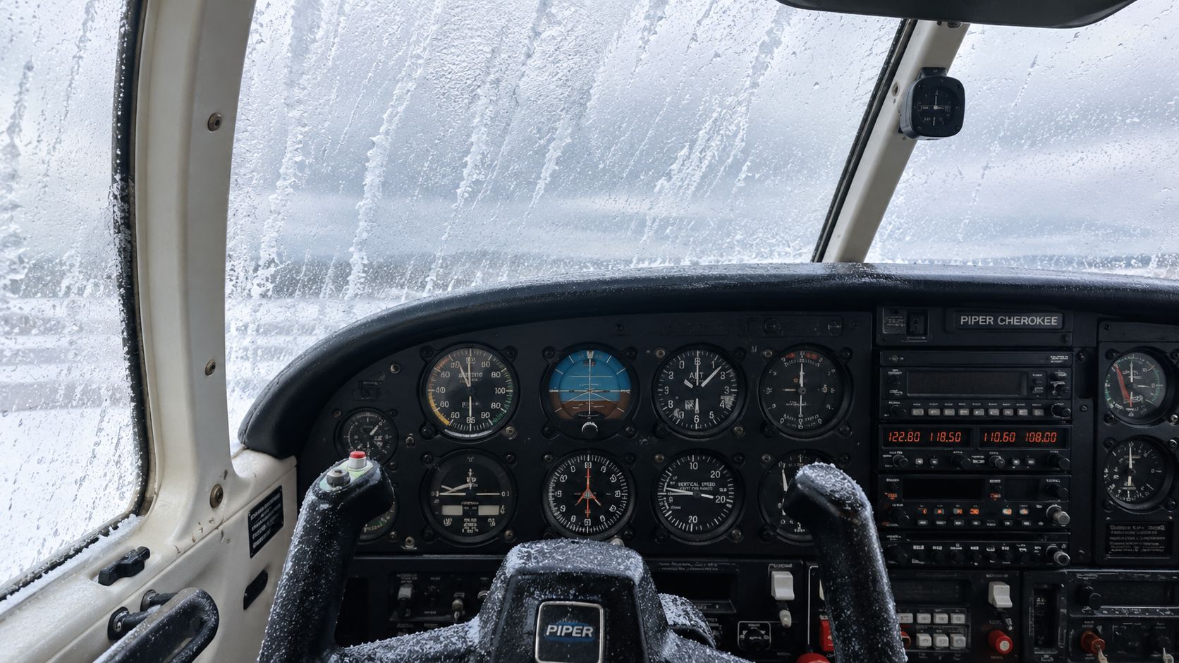 Icing Conditions Explained for Student and Private Pilots 4 A view from inside a Piper Cherokee cockpit showing windshield icing during flight in cold conditions.
