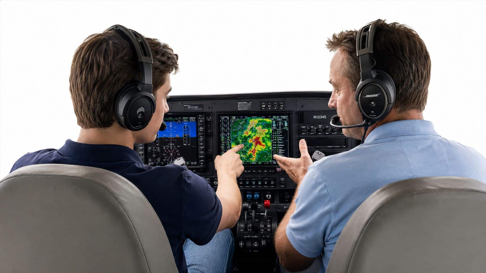 Private Pilot Study Guide That Actually Works 4 A flight instructor and a student pilot reviewing navigational charts and weather radar data inside a cockpit.