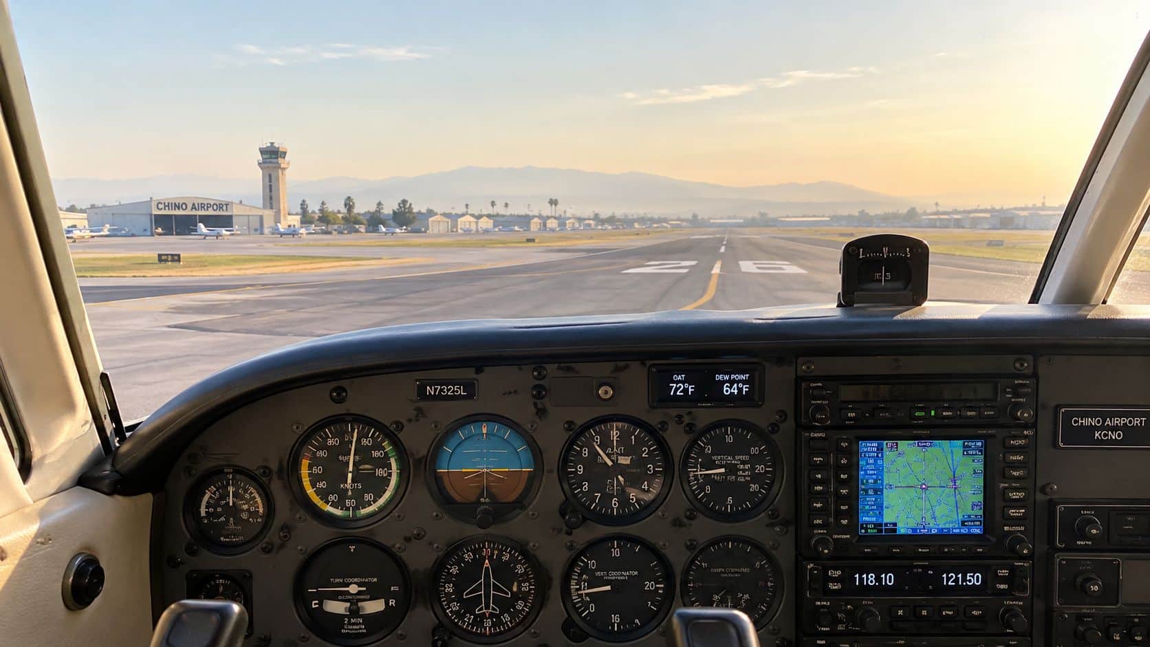 Tropical Air Mass: How Pilots Read Heat and Moisture 3 The view from inside a small airplane cockpit looking down an airport runway toward the horizon.